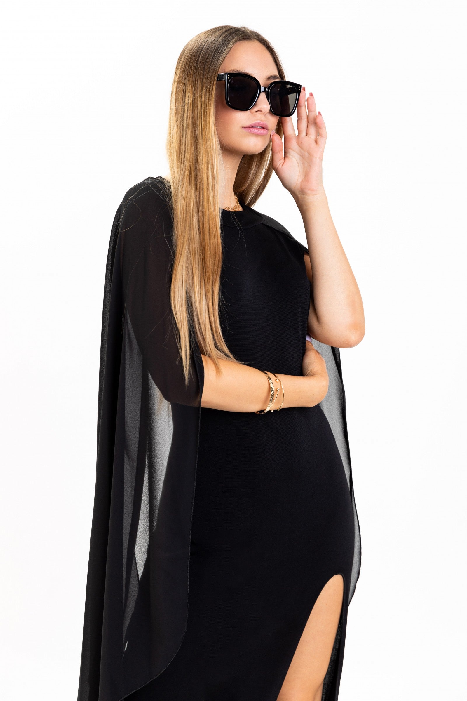 Elegant long black dress for women with translucent side panels and a side split, featuring a round collar and an invisible zipper at the back.