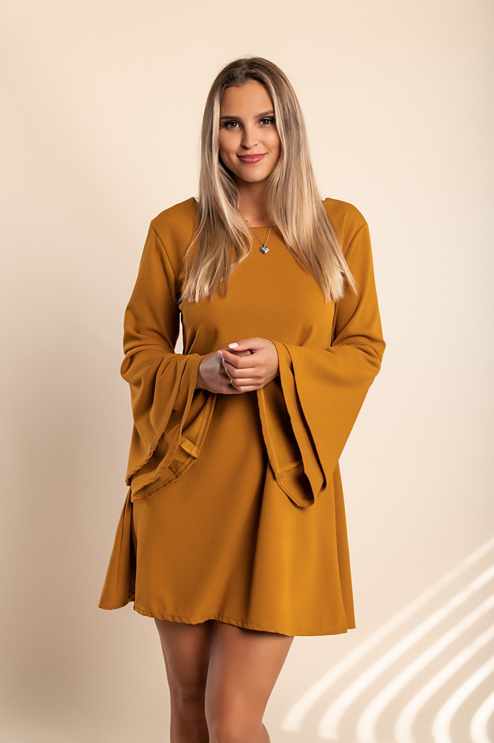 Stylish WOMEN DRESS RANIA in Mustard with bell sleeves and unique back design, perfect for modern looks.