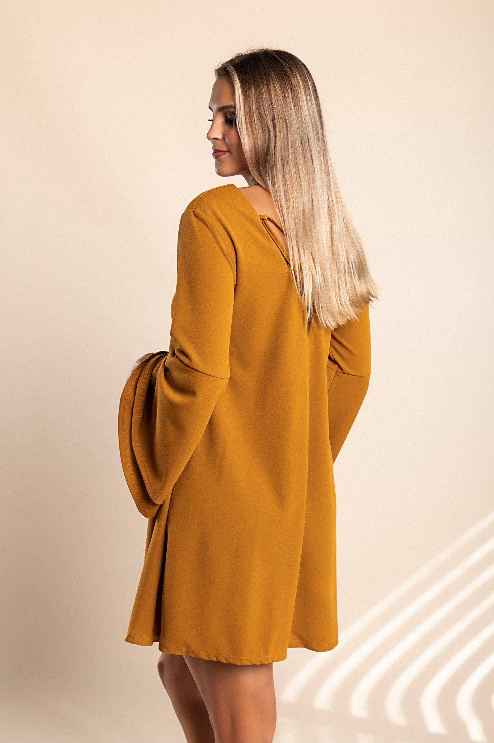 Stylish WOMEN DRESS RANIA in Mustard with bell sleeves and unique back design, perfect for modern looks.