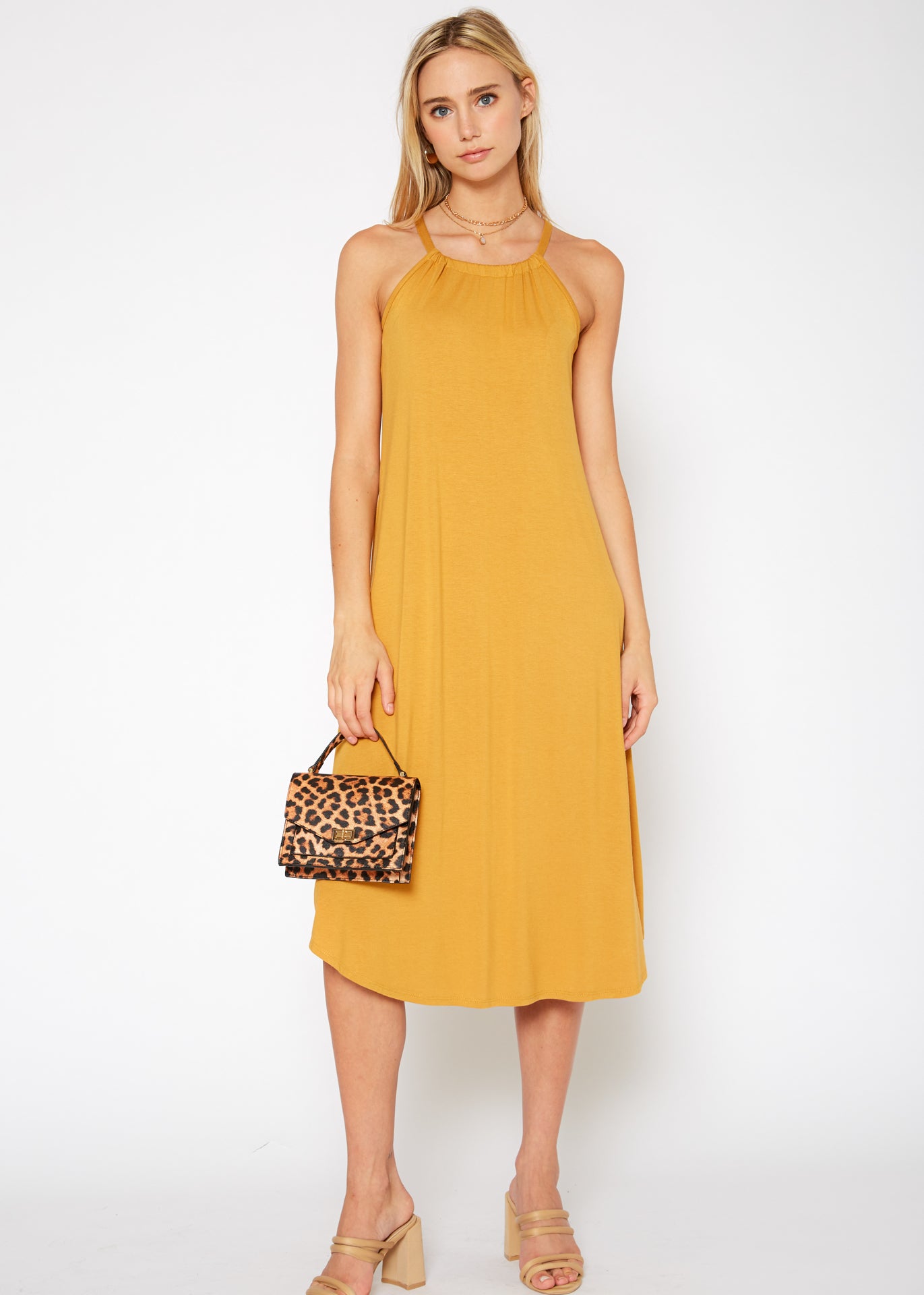 A stylish Women's Basic Haltered Dress featuring a halter neck design and rear neck tie, made from a soft rayon and spandex blend.