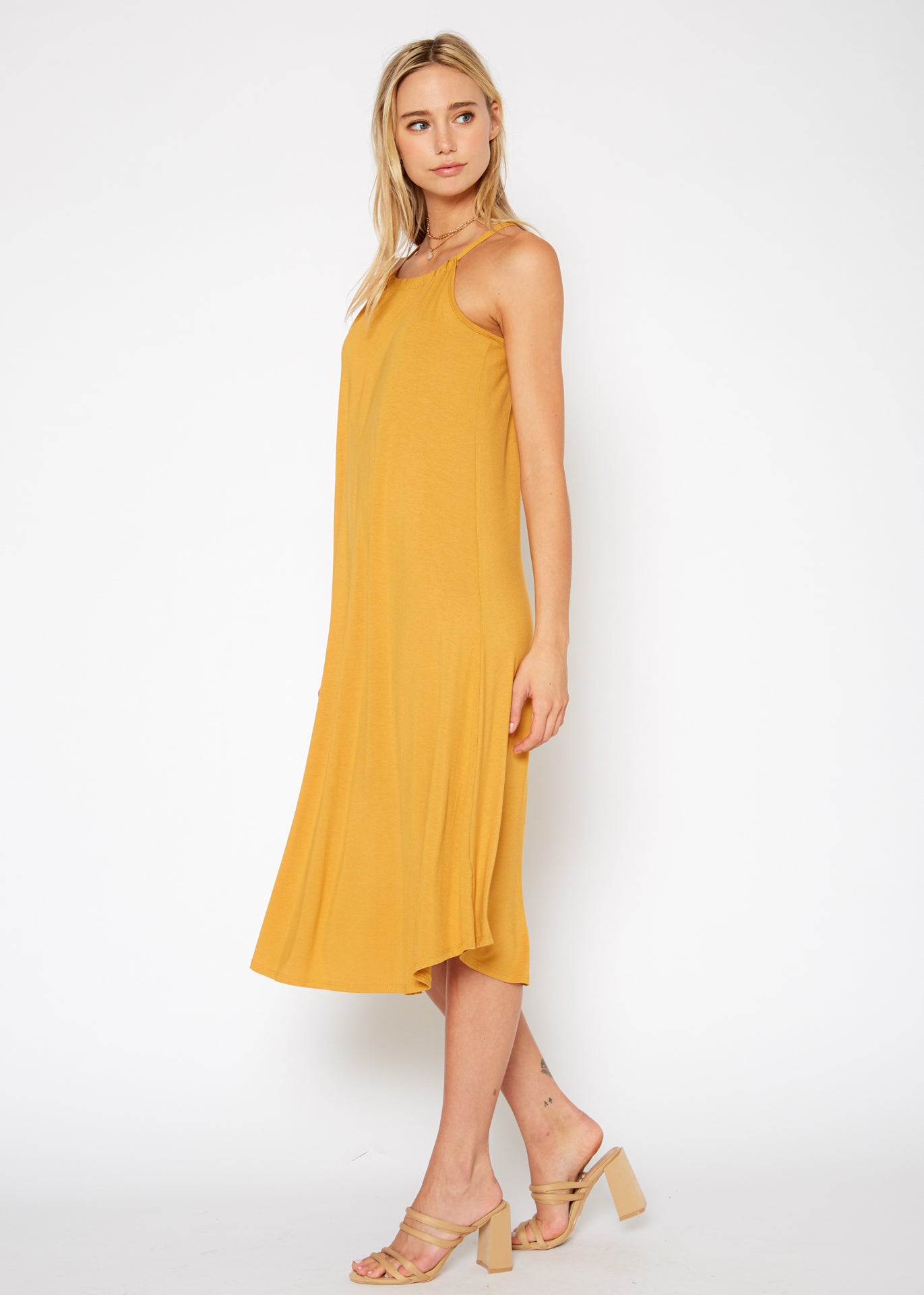 A stylish Women's Basic Haltered Dress featuring a halter neck design and rear neck tie, made from a soft rayon and spandex blend.