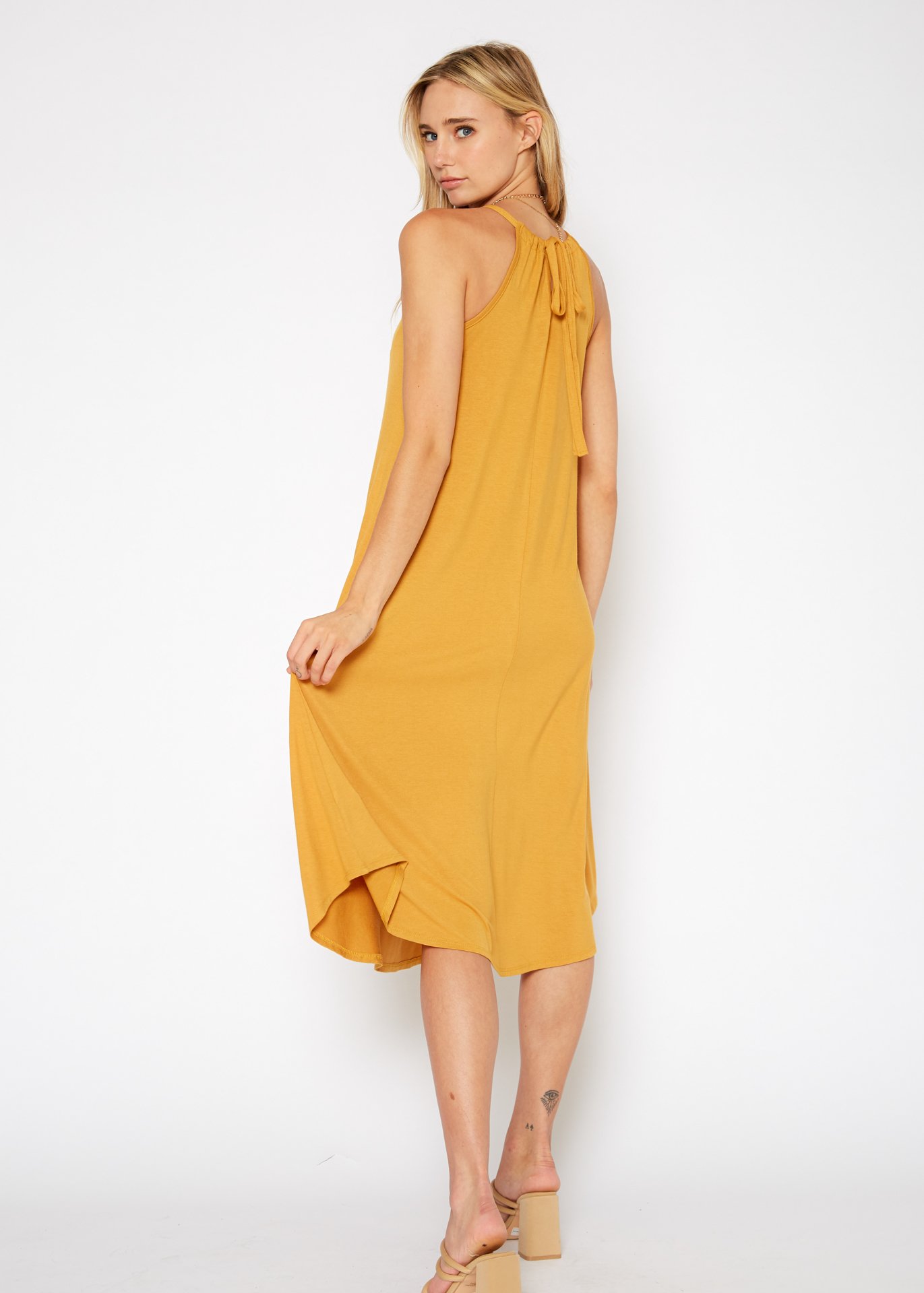 A stylish Women's Basic Haltered Dress featuring a halter neck design and rear neck tie, made from a soft rayon and spandex blend.