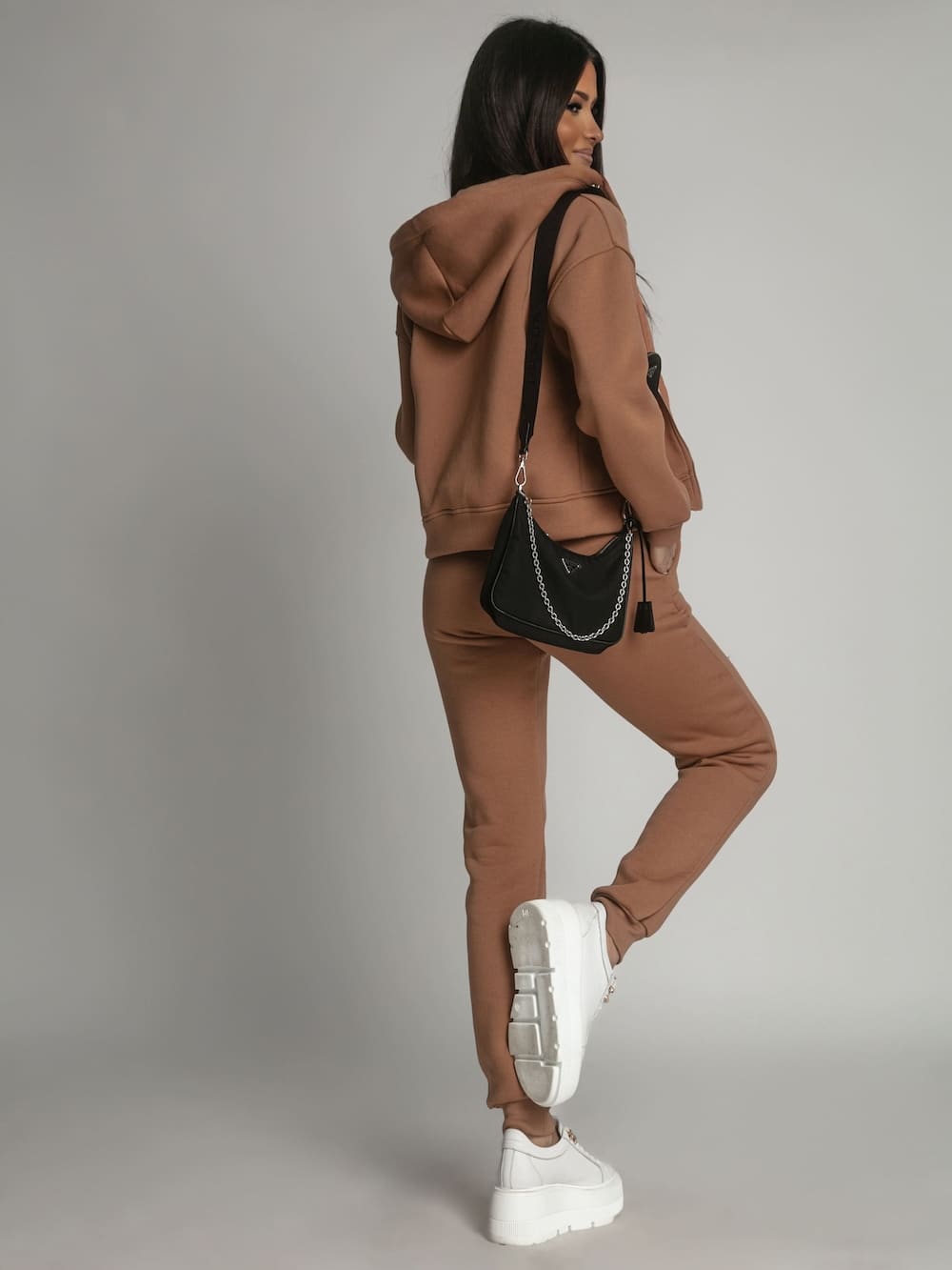 Women's beige insulated tracksuit set featuring a zipped sweatshirt with hood and elastic waist trousers, perfect for winter wear.