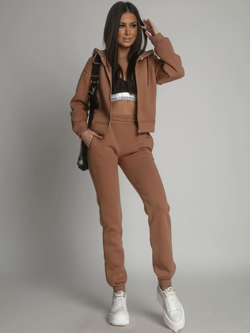 Women's beige insulated tracksuit set featuring a zipped sweatshirt with hood and elastic waist trousers, perfect for winter wear.