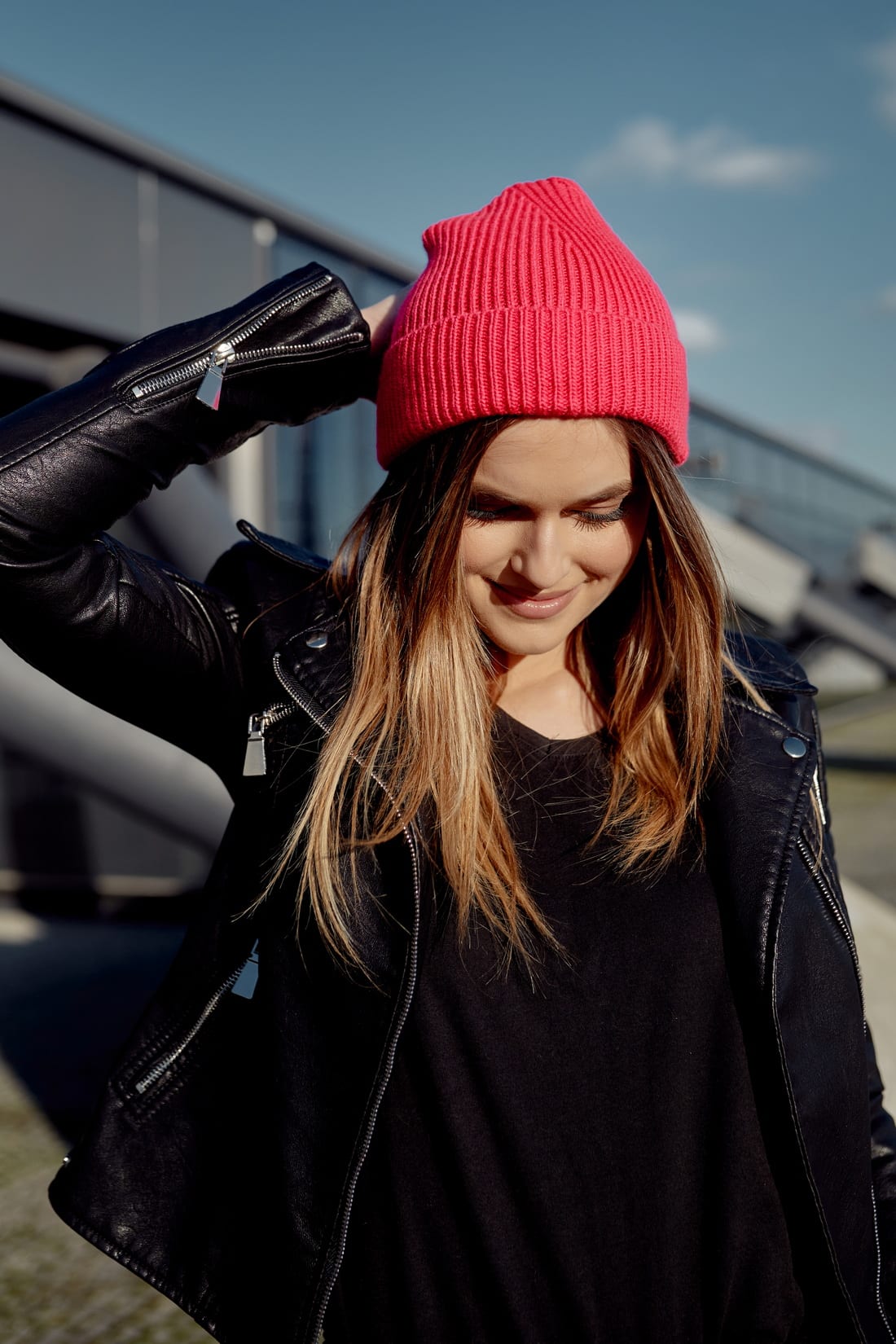 A stylish women's neon pink cap with a turn-up cuff, made from soft elastic sweater fabric, perfect for cold weather.