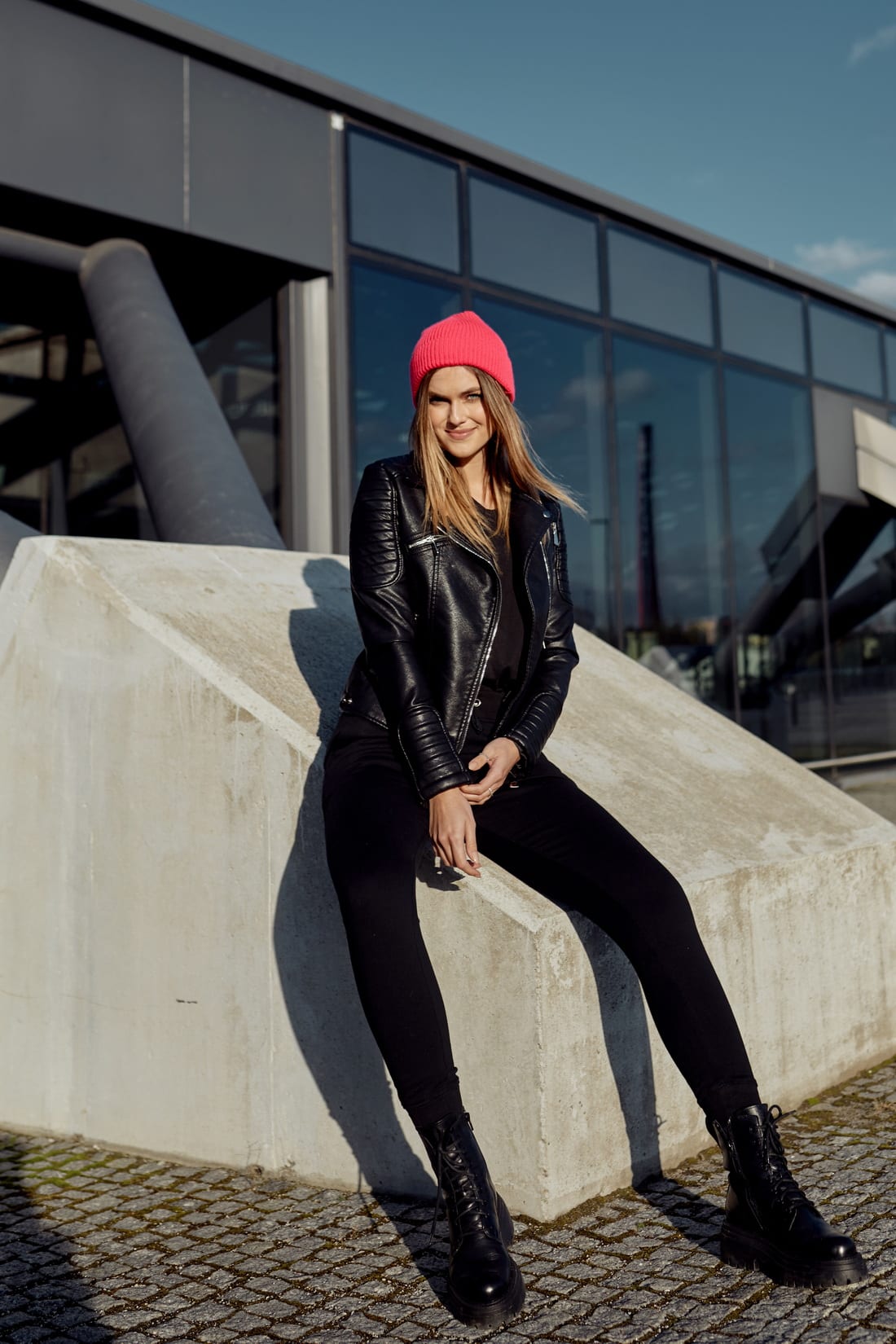 A stylish women's neon pink cap with a turn-up cuff, made from soft elastic sweater fabric, perfect for cold weather.