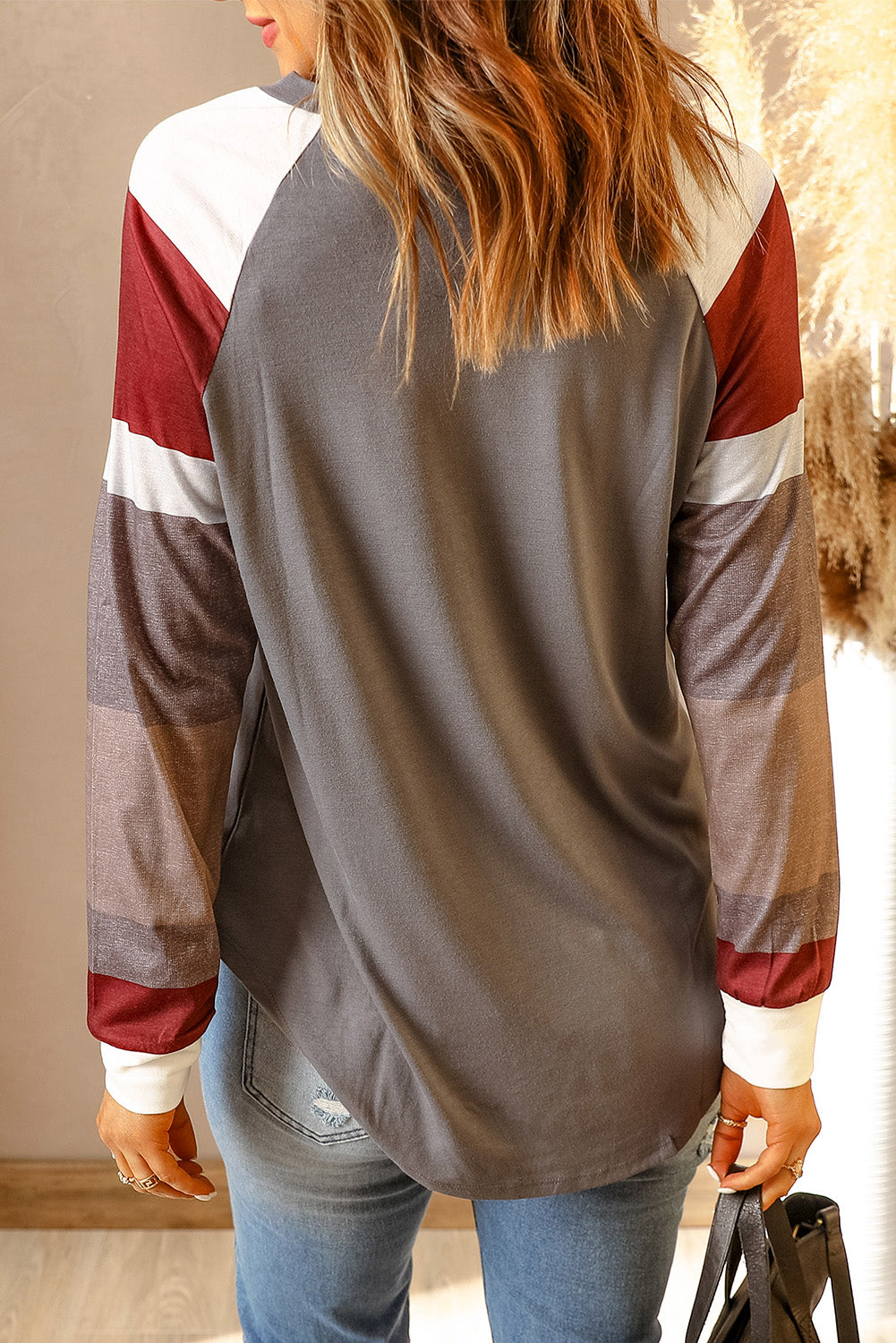 Women's gray pullover top featuring color blocked long sleeves, round neckline, and a loose fit, perfect for casual wear.