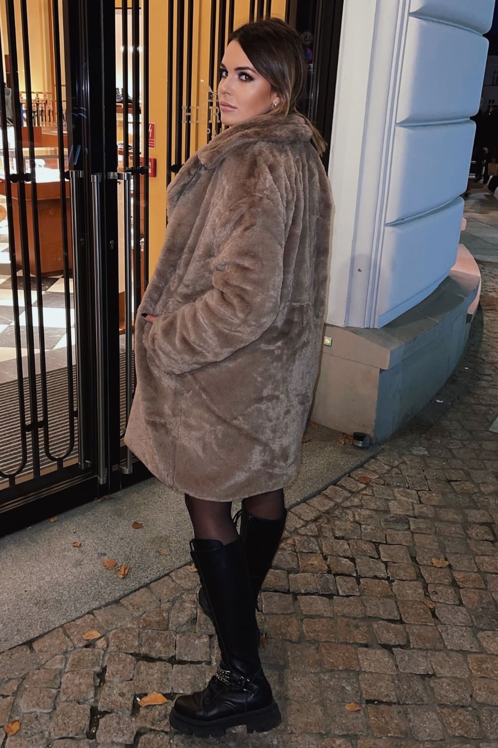 Women's dark beige fur coat with button fastening and side pockets, perfect for winter and autumn styles.