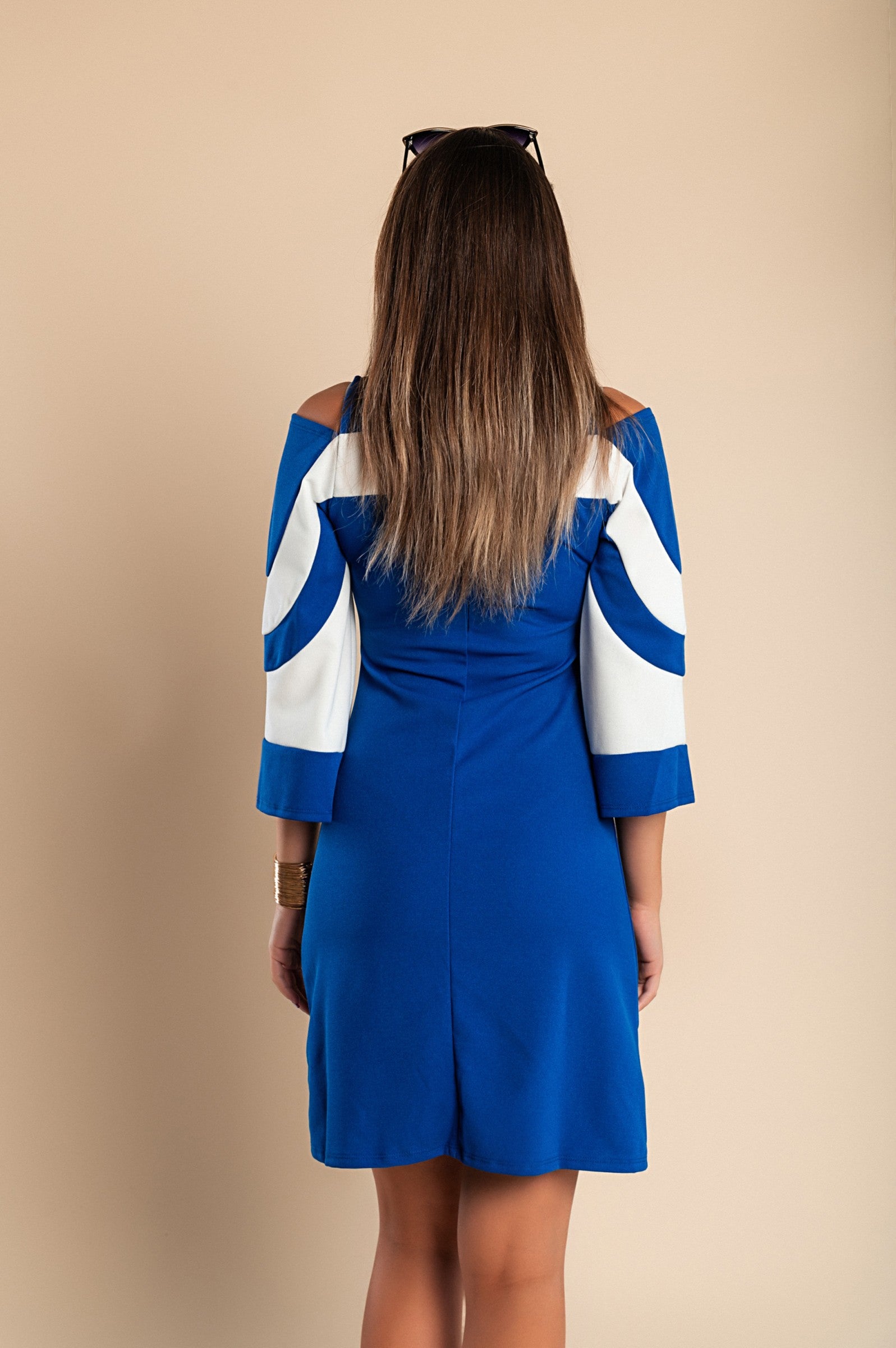 Elegant blue women's dress with 3/4 bell sleeves and mid-thigh length, featuring a back zipper and stylish arm slits.