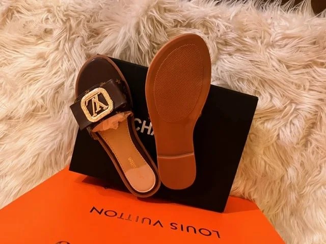 A pair of stylish Women's Fashion Flat Slide Sandals with LV design, perfect for casual wear and travel.