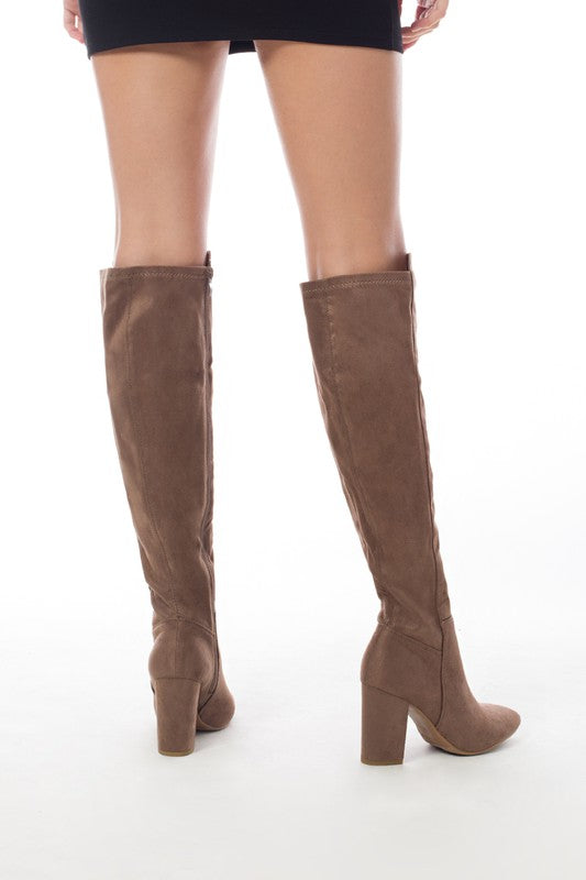 Women's knee-high boots made of faux suede with a block heel, showcasing a stylish and elegant design.