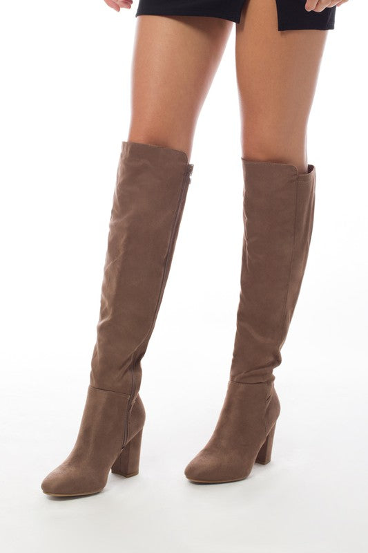 Women's knee-high boots made of faux suede with a block heel, showcasing a stylish and elegant design.