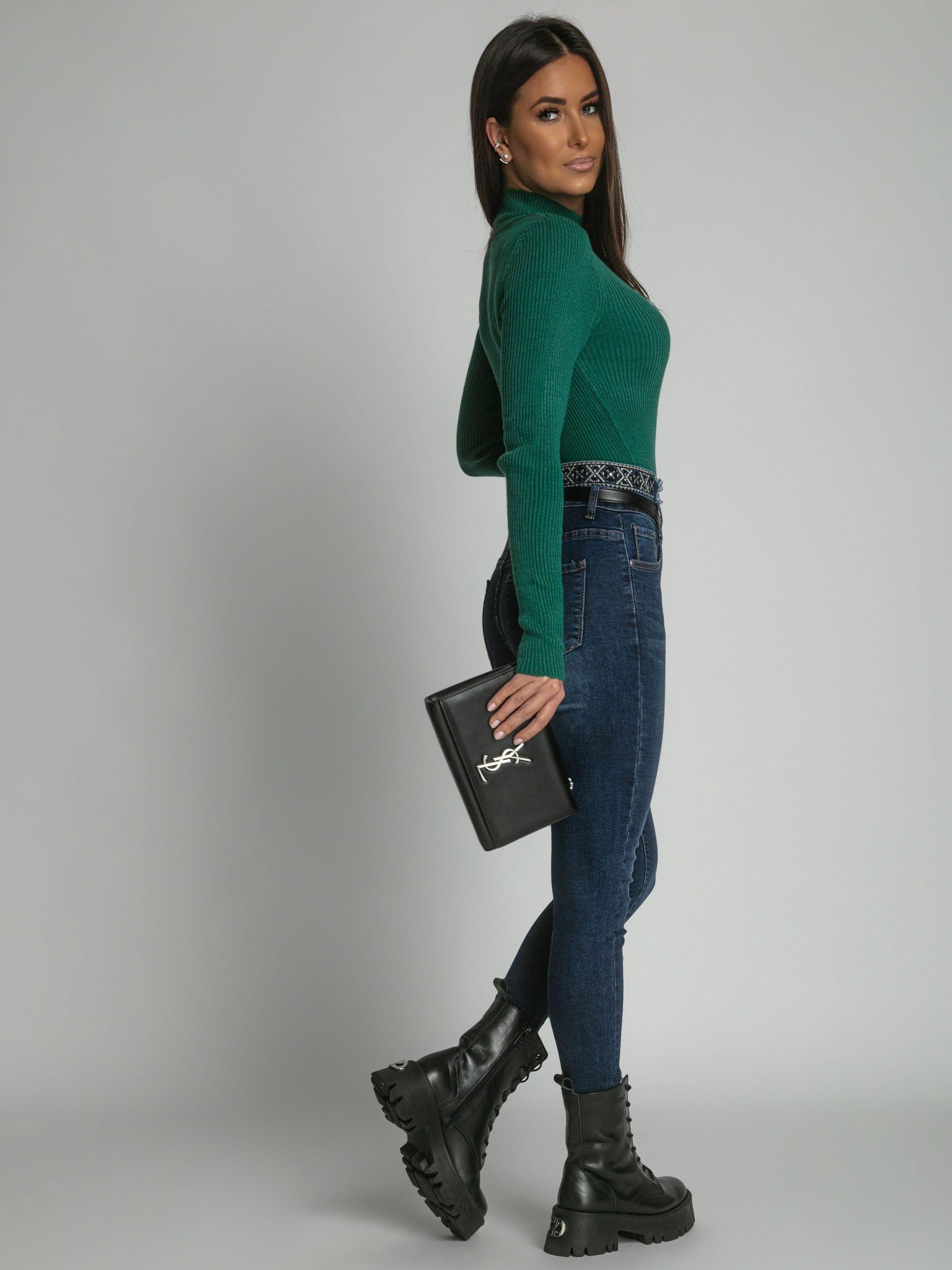 Women's fitted turtleneck sweater in bottle green, showcasing long sleeves and ribbed texture.