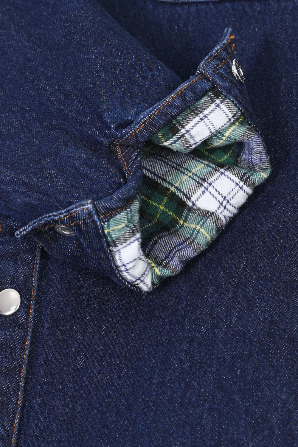 Women's flannel-lined denim shirt jacket featuring snap buttons, chest pockets, and side pockets, perfect for stylish warmth.