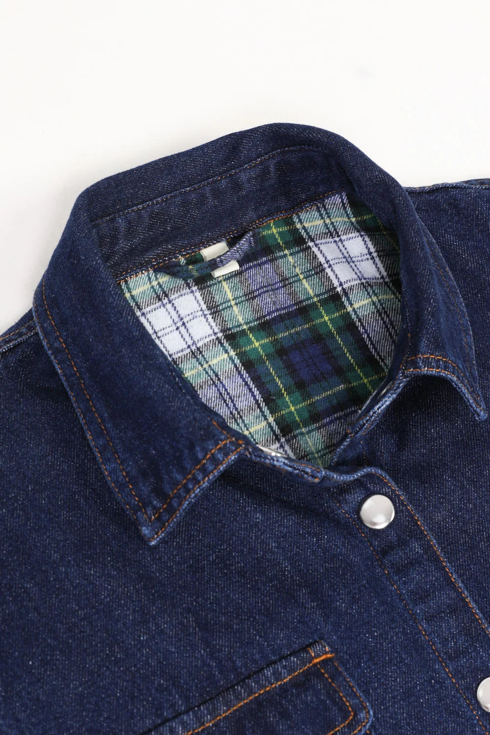 Women's flannel-lined denim shirt jacket featuring snap buttons, chest pockets, and side pockets, perfect for stylish warmth.