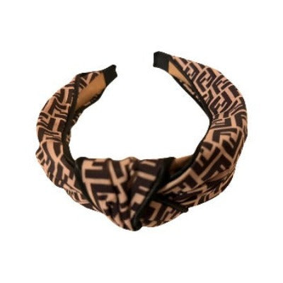 Stylish Women's HeadBand featuring a bow detail and grosgrain ribbon in shades of brown.