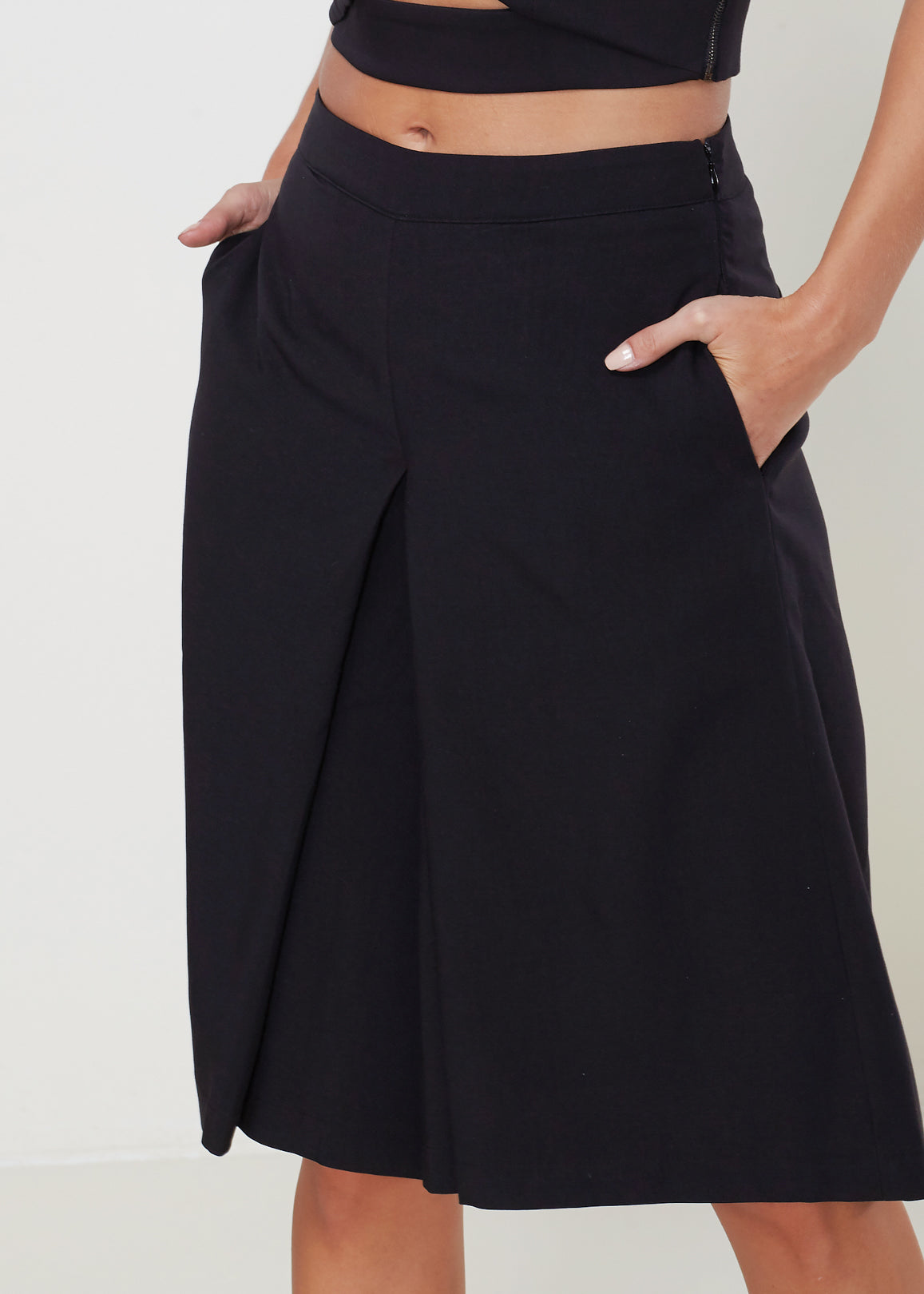 Women's High Rise Overlay Culottes featuring a skirt impression overlay and side pockets, made from high stretch twill fabric.