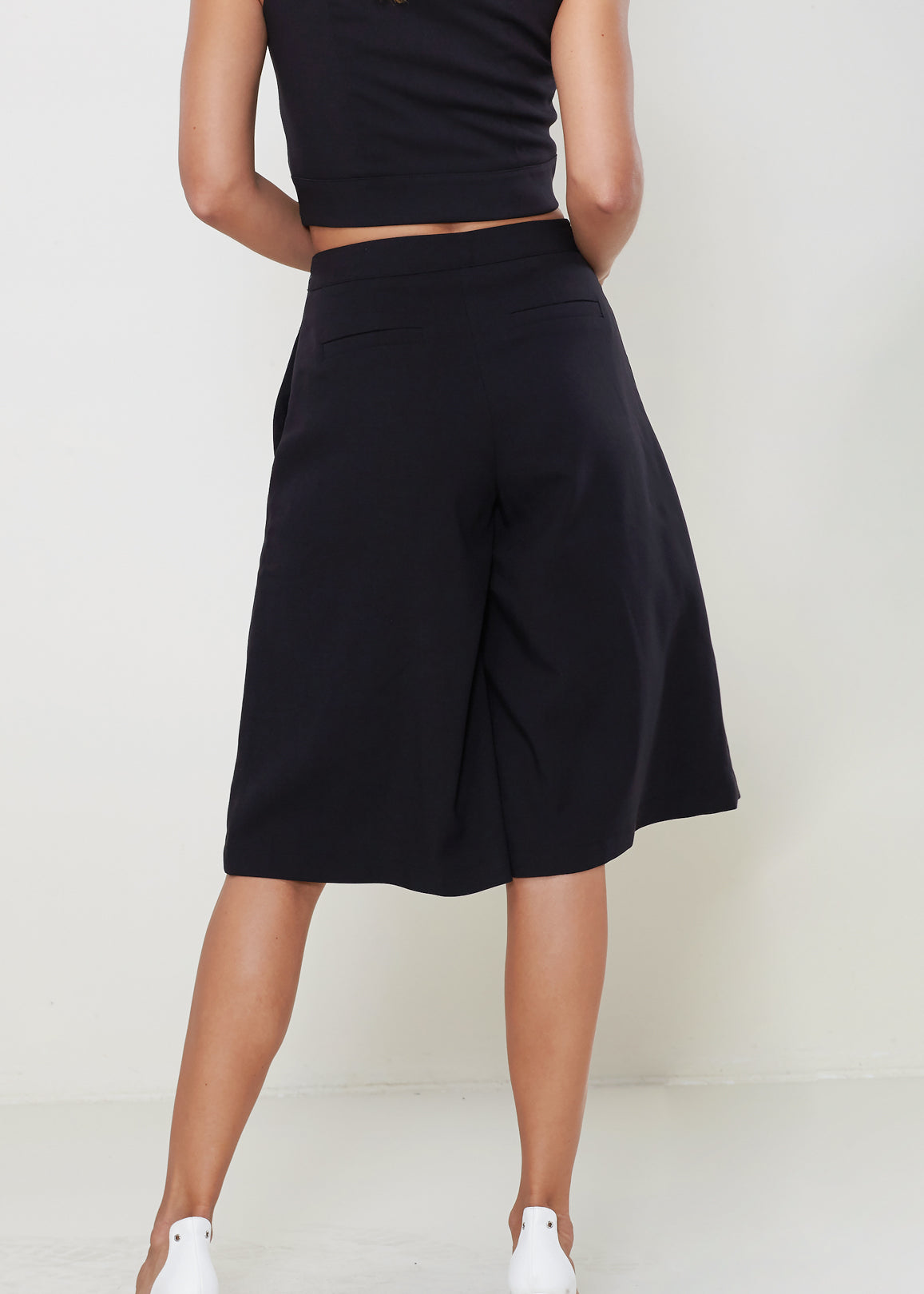 Women's High Rise Overlay Culottes featuring a skirt impression overlay and side pockets, made from high stretch twill fabric.