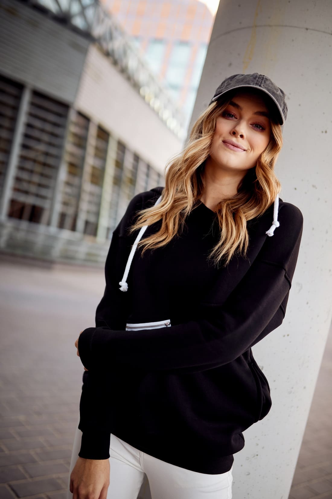 Women's black insulated sweatshirt with hood, featuring pockets and a stylish design, perfect for casual wear.