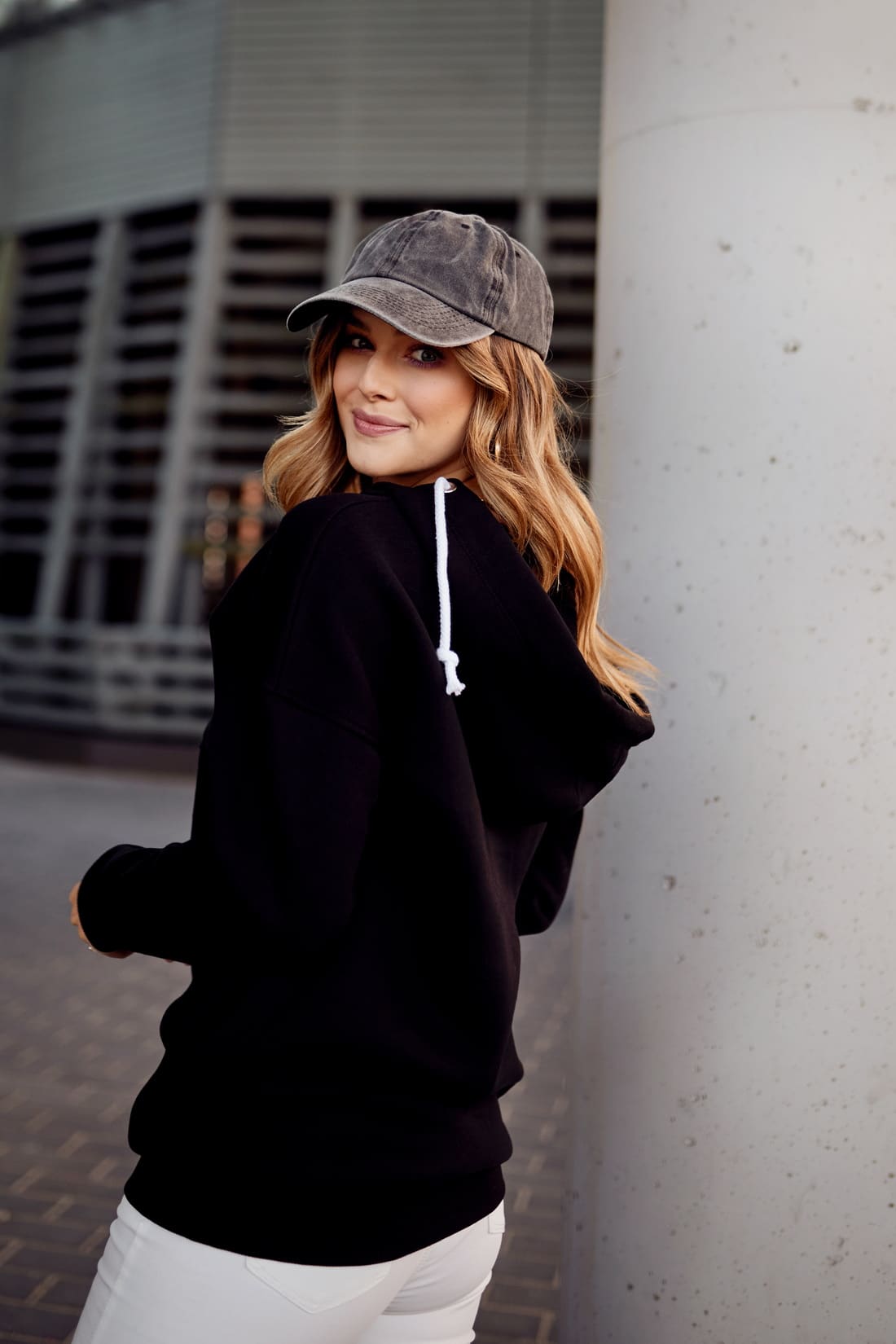 Women's black insulated sweatshirt with hood, featuring pockets and a stylish design, perfect for casual wear.