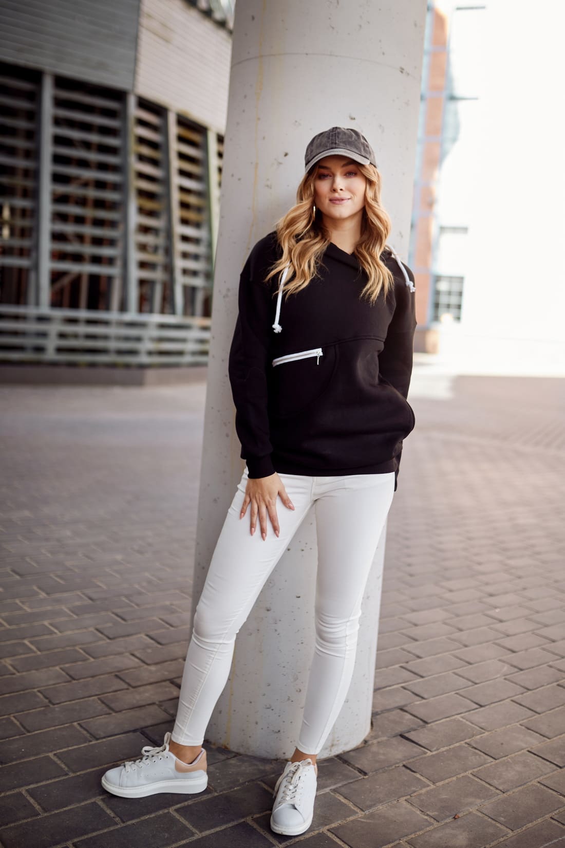 Women's black insulated sweatshirt with hood, featuring pockets and a stylish design, perfect for casual wear.