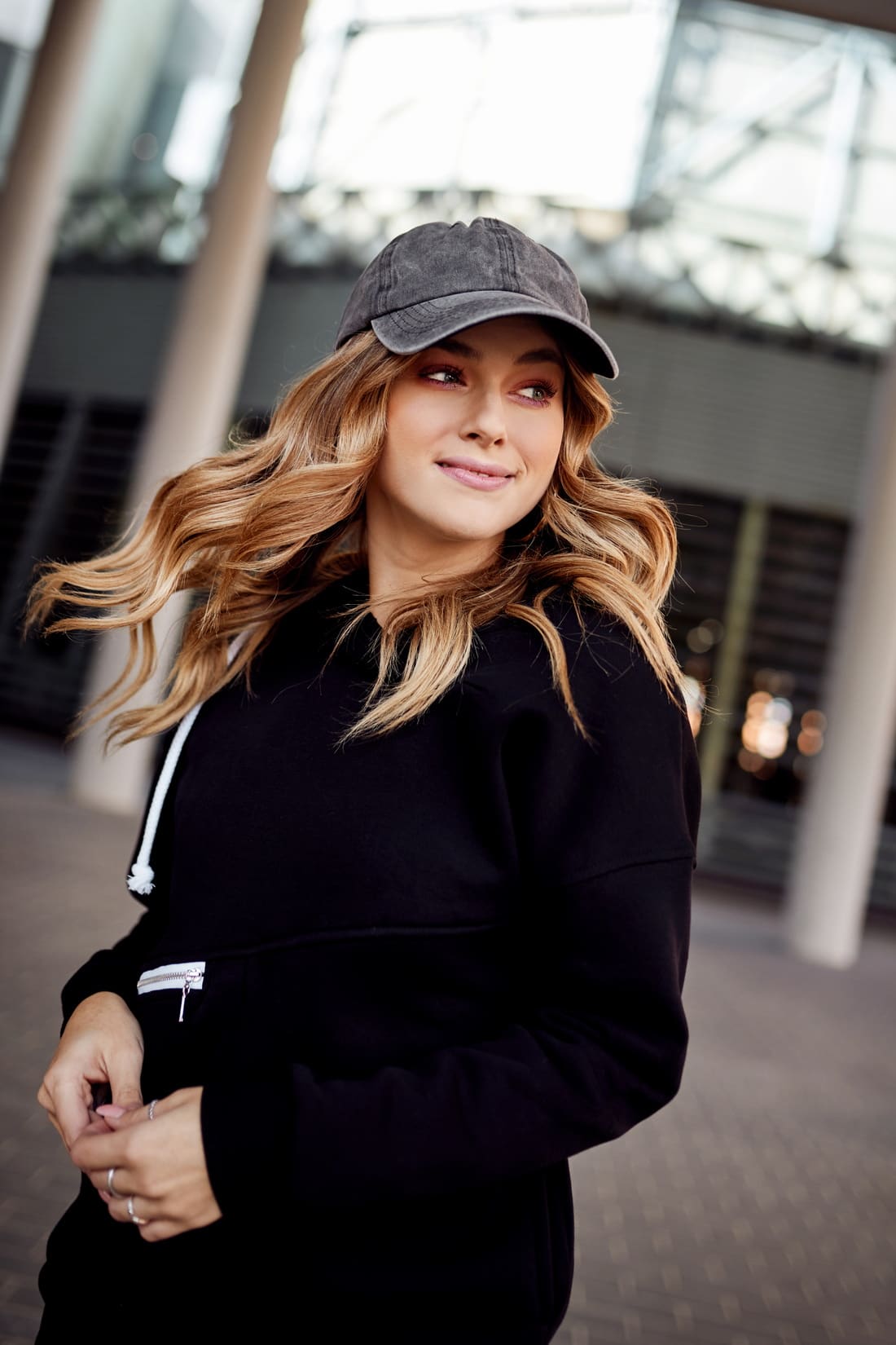 Women's black insulated sweatshirt with hood, featuring pockets and a stylish design, perfect for casual wear.