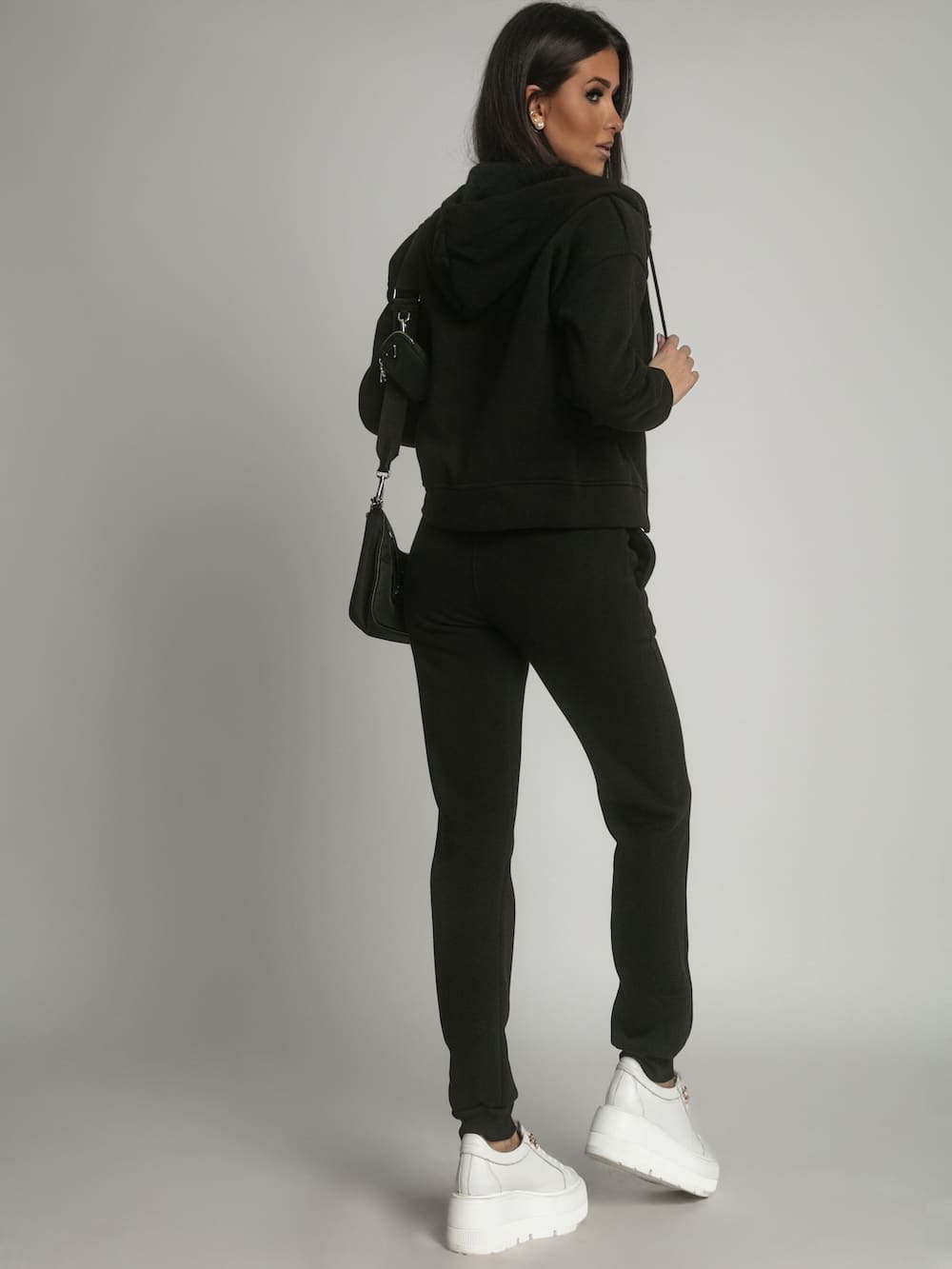 Women's insulated tracksuit set in black, featuring a zipped hoodie and elastic waist trousers with pockets, perfect for winter wear.