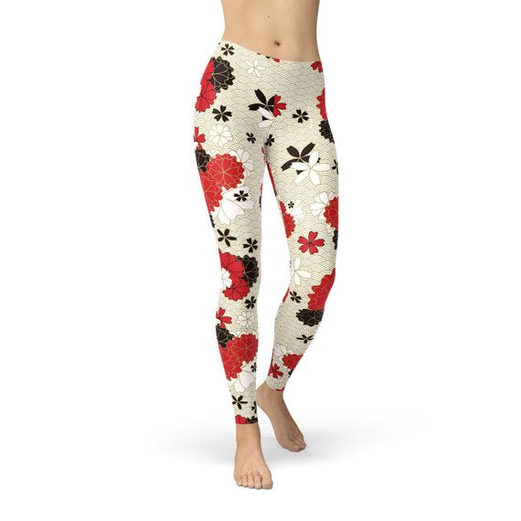 A pair of Women's Japanese Cherry Blossom Leggings featuring a vibrant cherry blossom design, made from a soft and stretchy fabric blend.