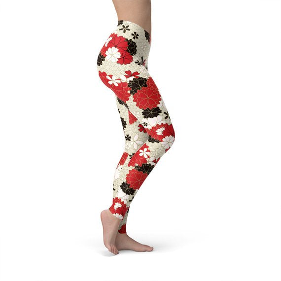 A pair of Women's Japanese Cherry Blossom Leggings featuring a vibrant cherry blossom design, made from a soft and stretchy fabric blend.