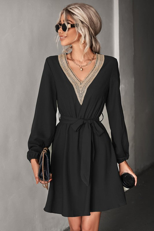 A stylish Women's Long Sleeve V Neck Mid Dress featuring elegant trim, made from a comfortable polyester and spandex blend.