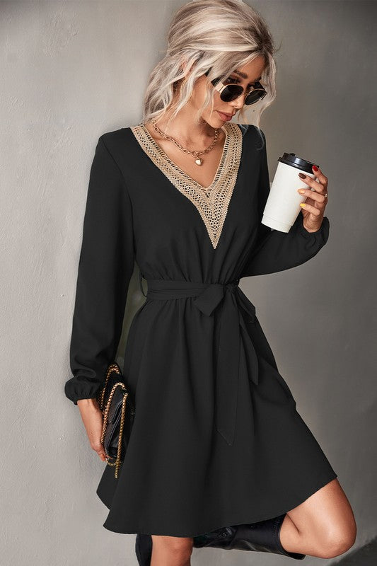 A stylish Women's Long Sleeve V Neck Mid Dress featuring elegant trim, made from a comfortable polyester and spandex blend.