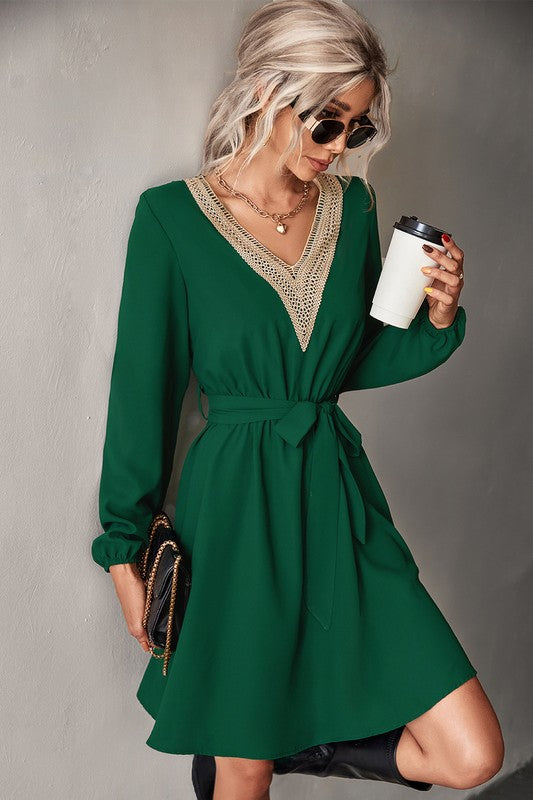 A stylish Women's Long Sleeve V Neck Mid Dress featuring elegant trim, made from a comfortable polyester and spandex blend.