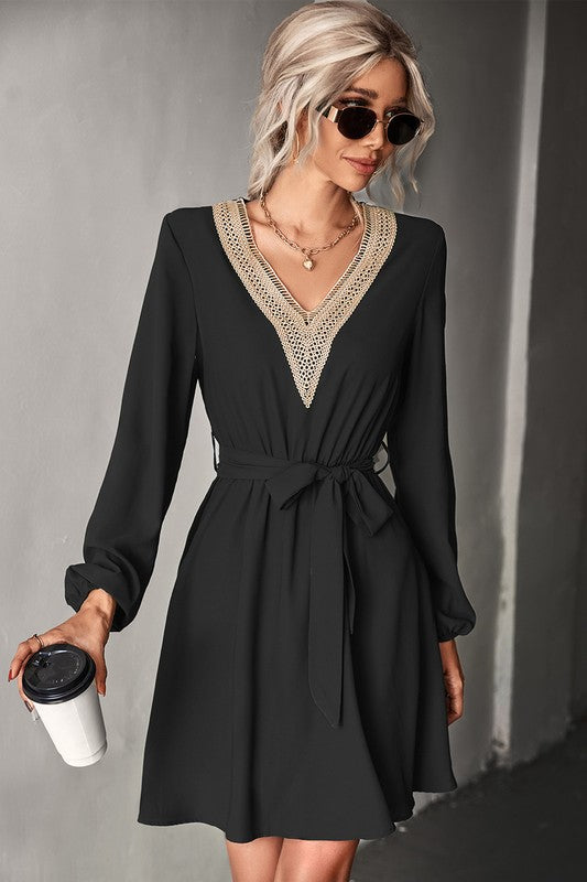 A stylish Women's Long Sleeve V Neck Mid Dress featuring elegant trim, made from a comfortable polyester and spandex blend.