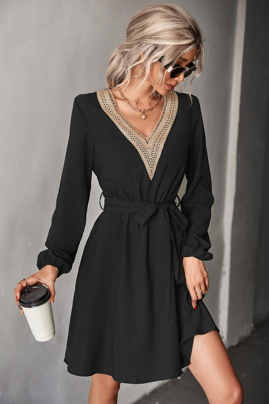 A stylish Women's Long Sleeve V Neck Mid Dress featuring elegant trim, made from a comfortable polyester and spandex blend.