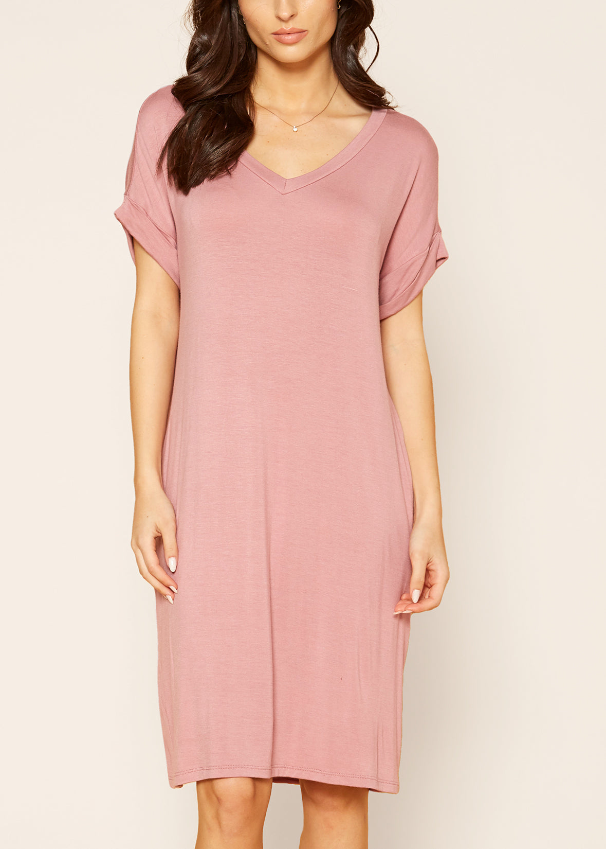 A stylish Women's Round Neck T-shirt Dress in a soft fabric, featuring a round neckline and convenient side pockets, perfect for casual wear.