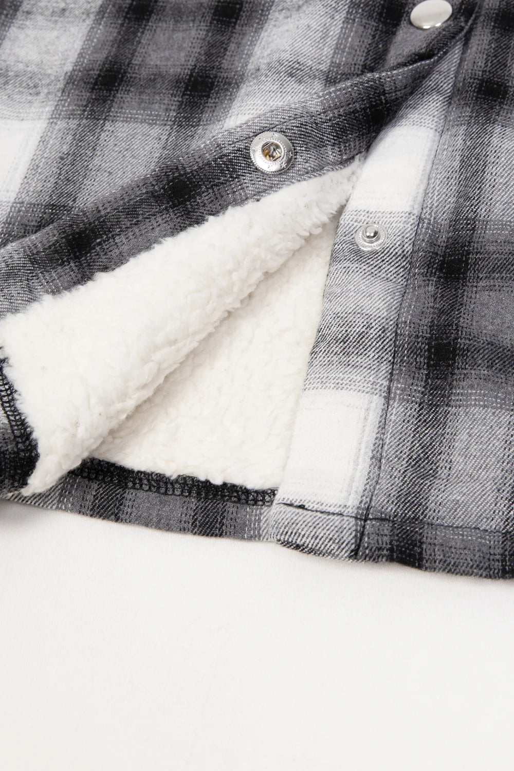 Women's Sherpa-Lined Flannel Jacket with Fleece Hood, featuring snap buttons and multiple pockets in a stylish plaid design.