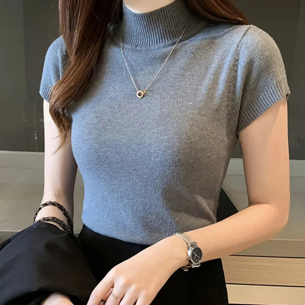 A stylish Women's Slim Fit Turtle Neck Short Sleeve Knitted Top in black, showcasing its elegant design and breathable fabric.