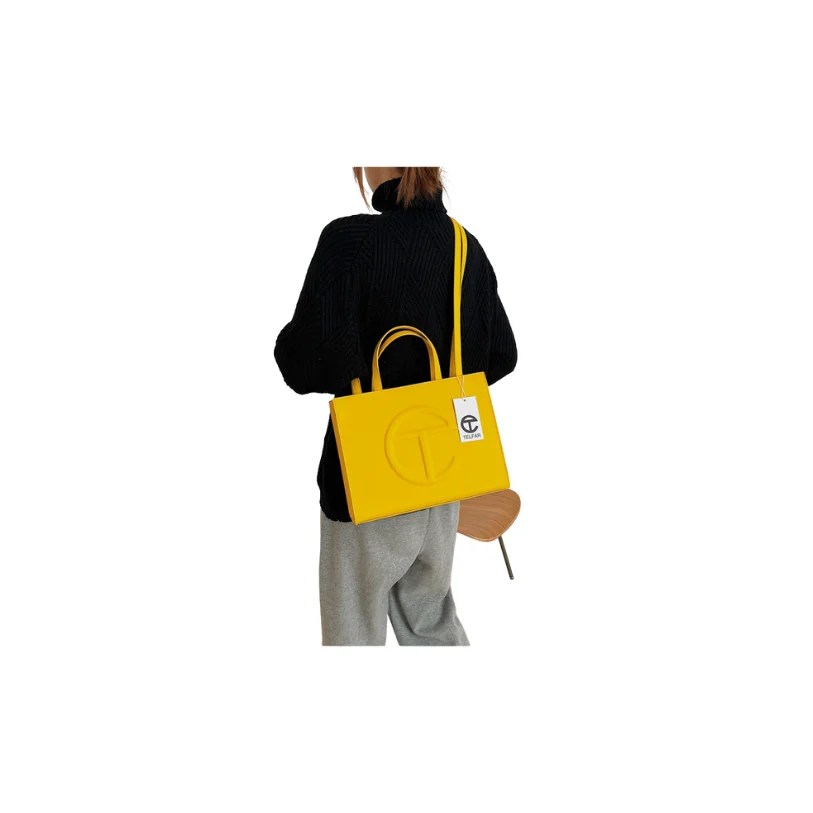 A stylish Women's Spring & Summer Fashion Handbag in a solid color, featuring a small square shape, single shoulder strap, and secure zipper closure.