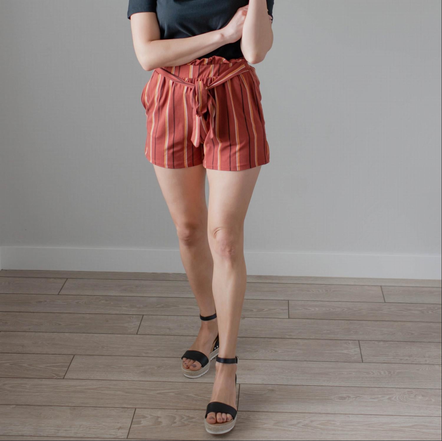 Women's high-waisted striped shorts with a waist tie, featuring a brushed stripe design and front pockets.