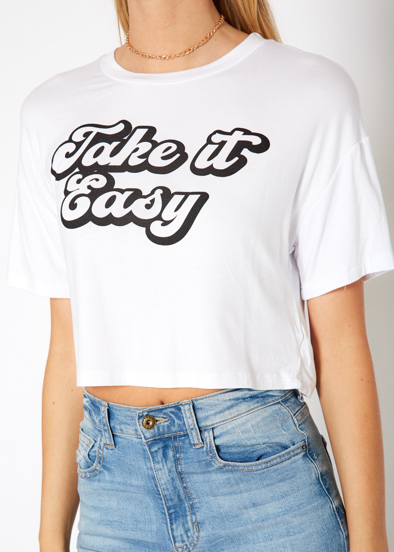 Women's 'Take it Easy' Printed Crop Top featuring a round neck and short sleeves, made from a soft rayon and spandex blend.