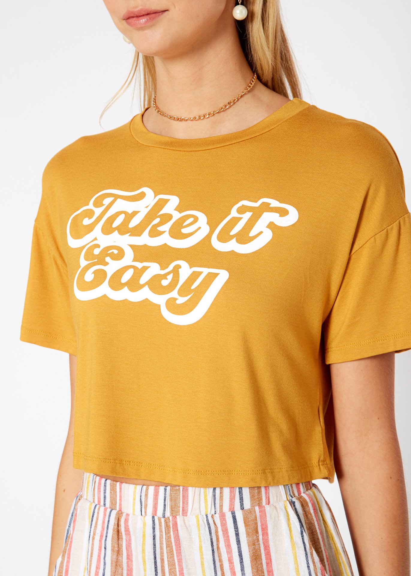 Women's 'Take it Easy' Printed Crop Top featuring a round neck and short sleeves, made from a soft rayon and spandex blend.