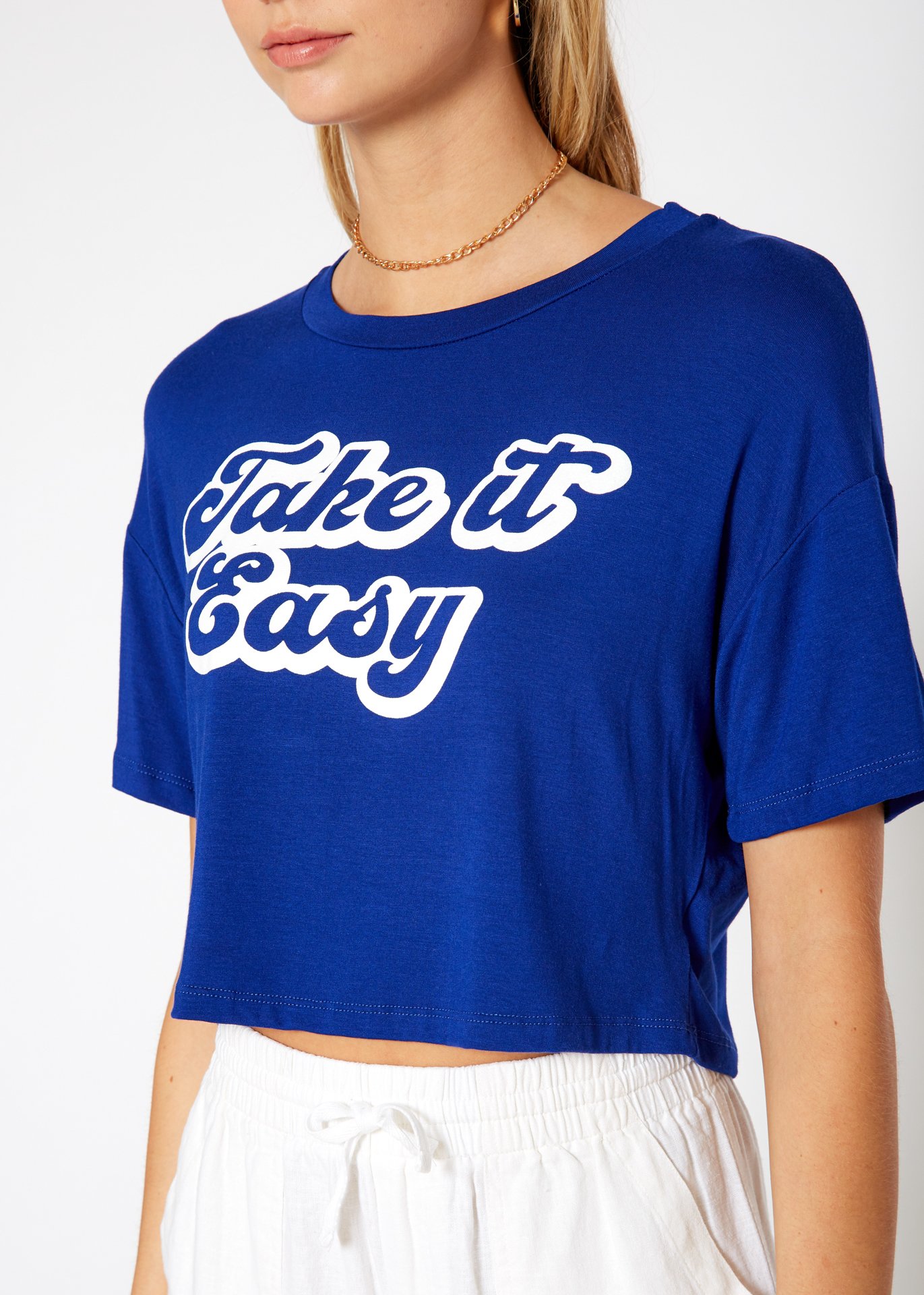 Women's 'Take it Easy' Printed Crop Top featuring a round neck and short sleeves, made from a soft rayon and spandex blend.