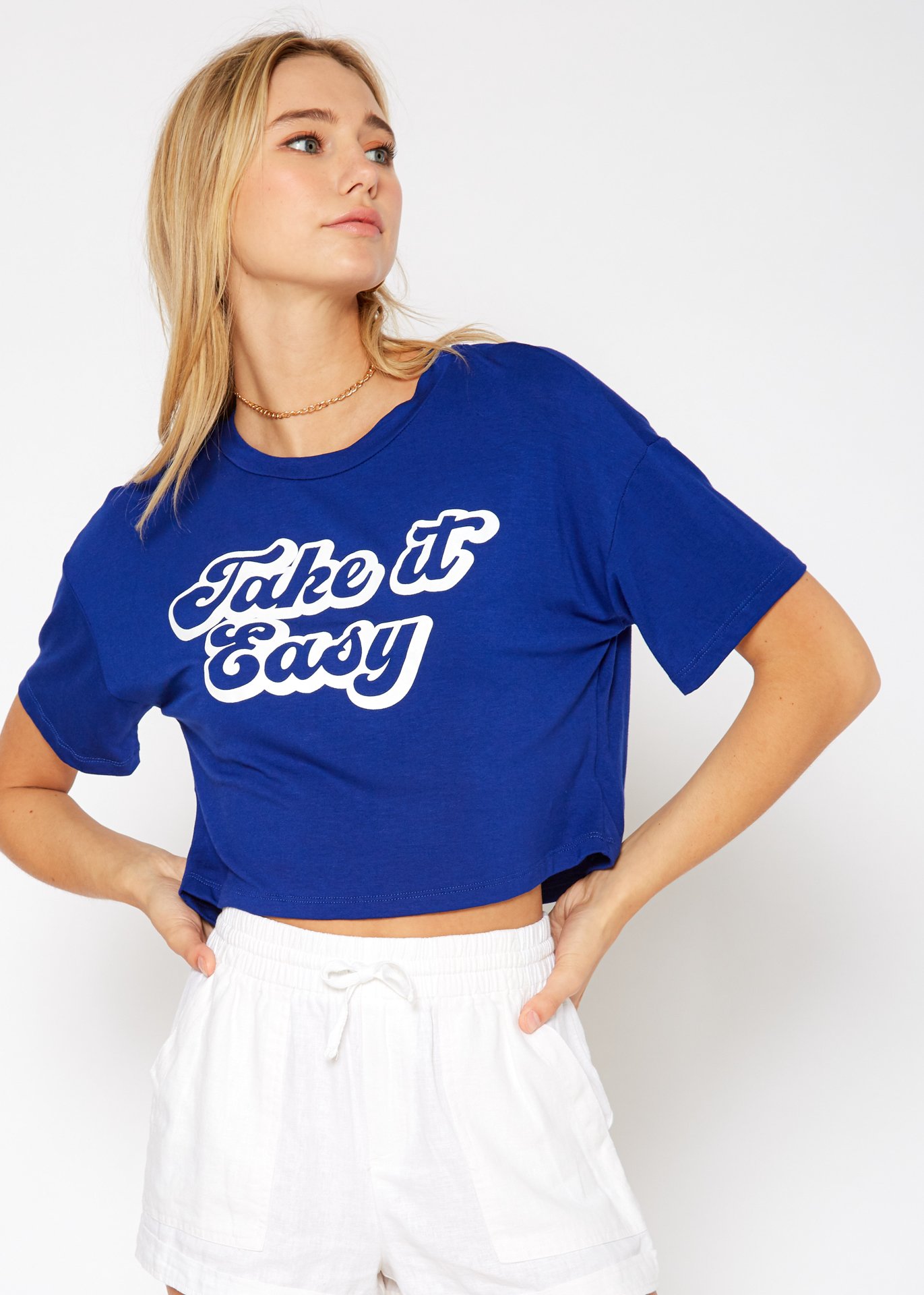 Women's 'Take it Easy' Printed Crop Top featuring a round neck and short sleeves, made from a soft rayon and spandex blend.