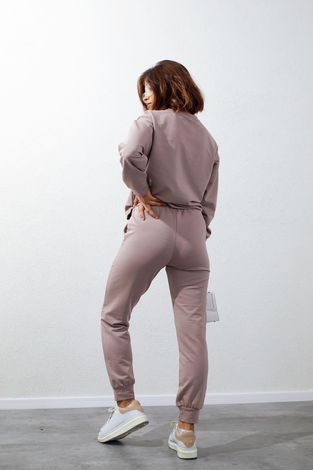 Women's tracksuit set in beige with cappuccino application, featuring long sleeves, elastic waist pants, and stylish inscriptions.