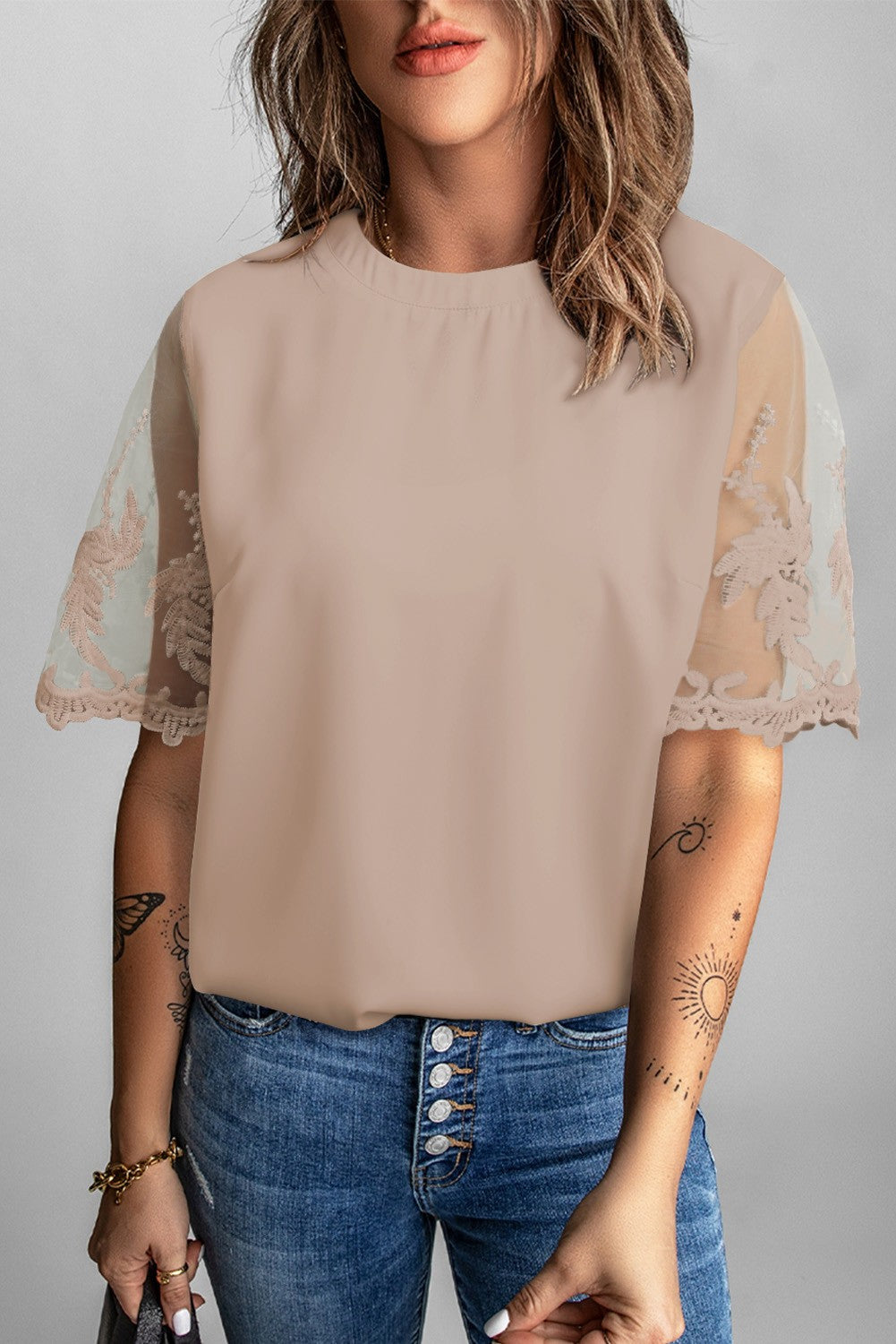 Women's apricot T-shirt with transparent lace sleeves, featuring a loose fit and round collar, perfect for casual and elegant wear.