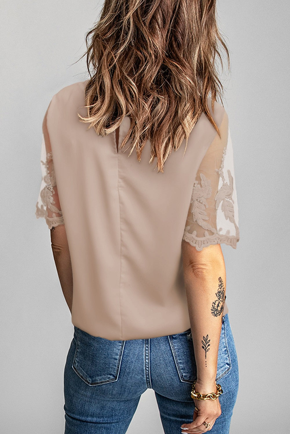 Women's apricot T-shirt with transparent lace sleeves, featuring a loose fit and round collar, perfect for casual and elegant wear.