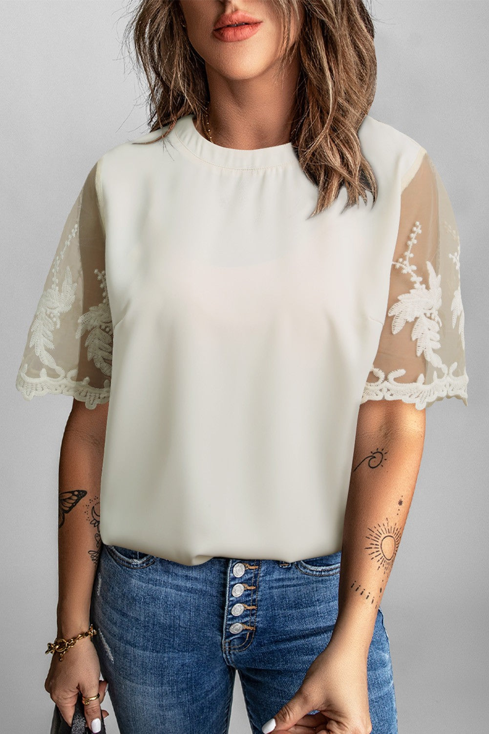 Women's white T-shirt with transparent lace sleeves, featuring a round collar and loose fit, perfect for casual and elegant wear.