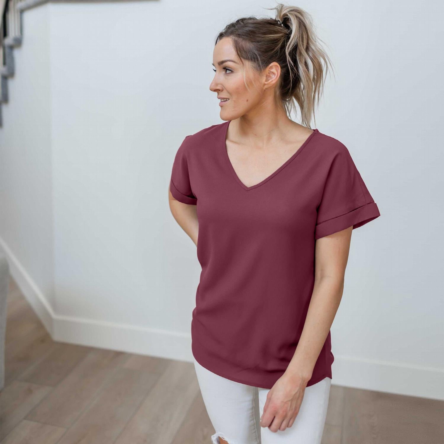 Woven Heavy Dobby Rolled Sleeve V-neck Top in bright pink, showcasing its loose fit and rolled sleeves.