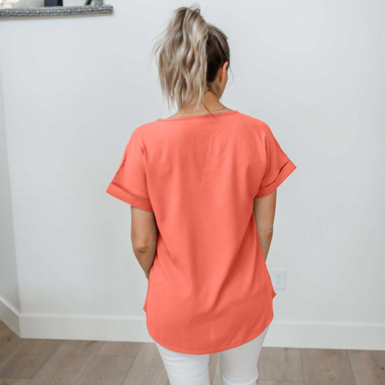 Woven Heavy Dobby Rolled Sleeve V-neck Top in bright pink, showcasing its loose fit and rolled sleeves.