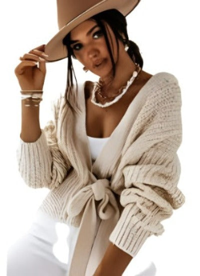 A stylish wrap over front belted cropped cardigan with puff sleeves, perfect for casual outfits.